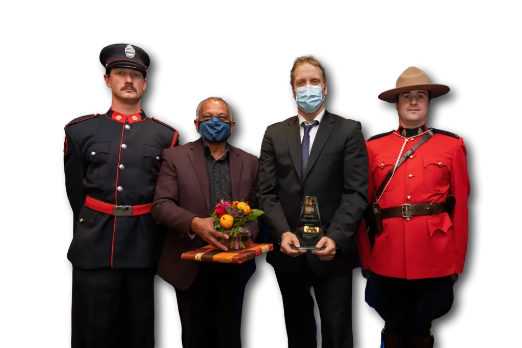 Jan Antons receiving award with members of the RCMP and council - Unleash Your Inner Strength